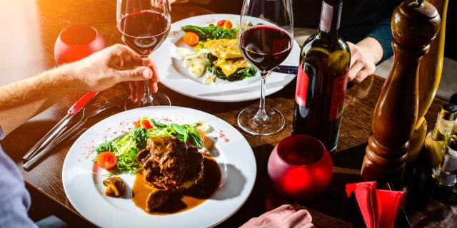 Couple having romantic dinner in a restaurant in rays of the sun